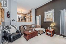 Living room with carpet floors, a textured ceiling, and an inviting chandelier - 