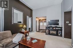 Carpeted living room with french doors and a textured ceiling - 