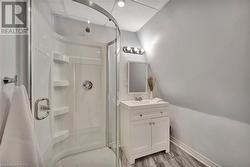 Bathroom with vanity, a shower and a toilet - 