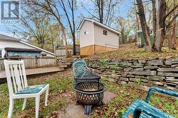 View of yard with a wooden deck and a fire pit - 