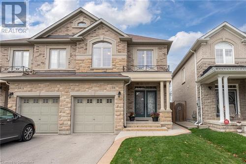 View of front of home with a garage and a balcony - 26 Summerberry Way, Hamilton, ON - Outdoor With Facade