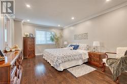 Bedroom with dark hardwood / wood-style floors and ornamental molding - 