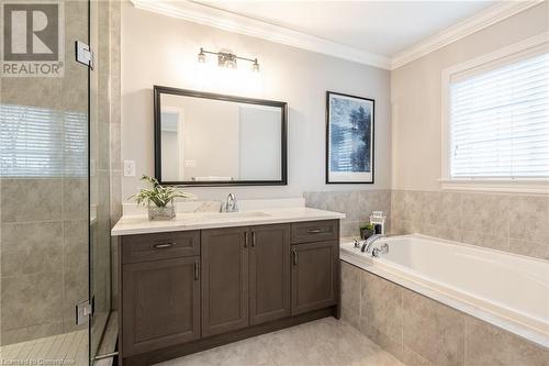 Bathroom featuring tile patterned flooring, vanity, separate shower and tub, and ornamental molding - 26 Summerberry Way, Hamilton, ON - Indoor Photo Showing Bathroom