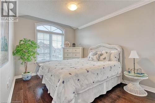 Bedroom featuring a textured ceiling, dark hardwood / wood-style floors, and crown molding - 26 Summerberry Way, Hamilton, ON - Indoor Photo Showing Bedroom