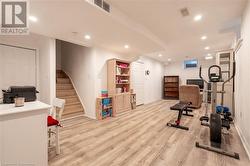 Workout area featuring light wood-type flooring - 