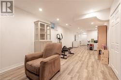 Exercise room with light wood-type flooring and washer / clothes dryer - 