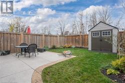 View of yard with a patio area and a storage unit - 