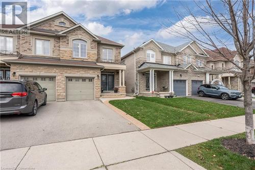 Multi unit property featuring a garage and a front yard - 26 Summerberry Way, Hamilton, ON - Outdoor With Facade