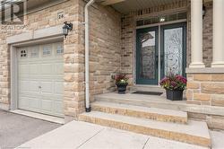 Doorway to property featuring a garage - 