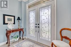 Foyer entrance with crown molding and french doors - 