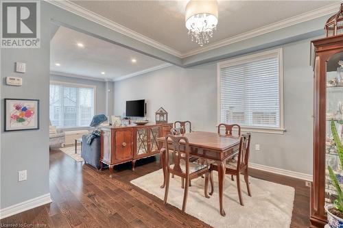 Dining room with a chandelier, a textured ceiling, dark hardwood / wood-style flooring, and crown molding - 26 Summerberry Way, Hamilton, ON - Indoor Photo Showing Dining Room