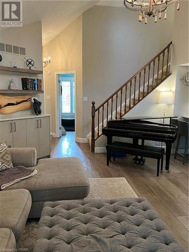 Living room featuring light hardwood / wood-style flooring, high vaulted ceiling, and an inviting chandelier - 1550 Gordon Street Unit# 8, Guelph, ON - Indoor Photo Showing Other Room