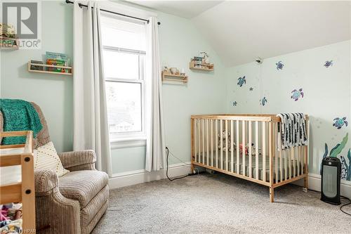 Bedroom featuring a crib, carpet floors, and lofted ceiling - 175 Mcnab St, Stratford, ON - Indoor Photo Showing Bedroom