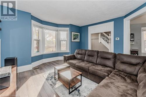 Living room featuring hardwood / wood-style floors and a textured ceiling - 20 Sarah Street, Brantford, ON - Indoor Photo Showing Living Room