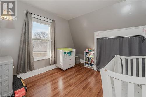 Bedroom featuring hardwood / wood-style flooring, lofted ceiling, and a nursery area - 20 Sarah Street, Brantford, ON - Indoor Photo Showing Bedroom