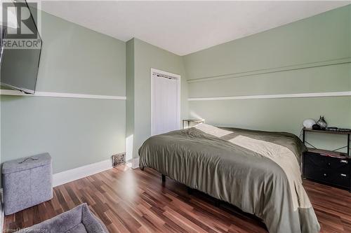 Bedroom with dark hardwood / wood-style flooring - 20 Sarah Street, Brantford, ON - Indoor Photo Showing Bedroom