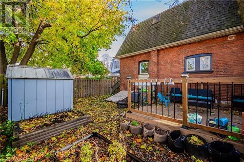 Wooden terrace with an outdoor living space and a storage shed - 20 Sarah Street, Brantford, ON - Outdoor