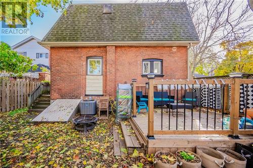 Wooden deck featuring an outdoor living space with a fire pit and cooling unit - 20 Sarah Street, Brantford, ON - Outdoor With Deck Patio Veranda With Exterior