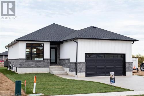 View of front of home with a front lawn and a garage - 323 Mclean Crescent, Saugeen Shores, ON - Outdoor