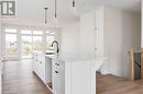 Kitchen featuring pendant lighting, light hardwood / wood-style floors, sink, and an island with sink - 323 Mclean Crescent, Saugeen Shores, ON  - Indoor Photo Showing Other Room 