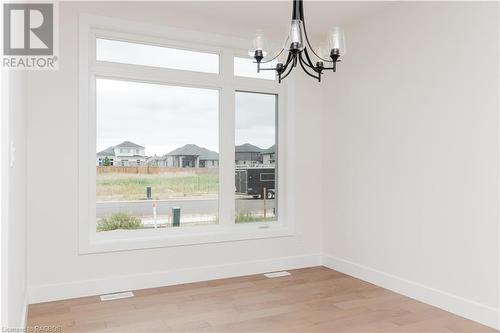 Unfurnished dining area featuring hardwood / wood-style floors and a chandelier - 323 Mclean Crescent, Saugeen Shores, ON - Indoor Photo Showing Other Room