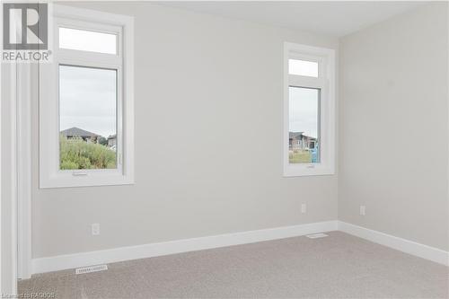 Carpeted bedroom with a healthy amount of sunlight - 323 Mclean Crescent, Saugeen Shores, ON - Indoor Photo Showing Other Room