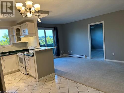 Living room with walk out to large balcony - 2373 King Street E Unit# 48, Hamilton, ON - Indoor Photo Showing Kitchen With Double Sink