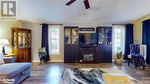 Living room with dark hardwood / wood-style floors, ceiling fan, and a textured ceiling - 69 St James Place, Wasaga Beach, ON - Indoor Photo Showing Living Room