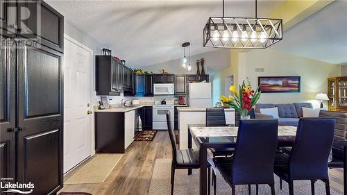 Dining room with a textured ceiling, sink, lofted ceiling, and hardwood / wood-style flooring - 69 St James Place, Wasaga Beach, ON - Indoor Photo Showing Dining Room