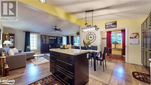 Kitchen with decorative light fixtures, a kitchen island, plenty of natural light, and lofted ceiling - 69 St James Place, Wasaga Beach, ON - Indoor