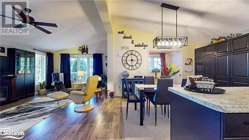 Dining room featuring hardwood / wood-style floors, a textured ceiling, vaulted ceiling, and ceiling fan - 69 St James Place, Wasaga Beach, ON - Indoor