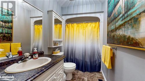 Bathroom with a shower with curtain, vanity, and toilet - 69 St James Place, Wasaga Beach, ON - Indoor Photo Showing Bathroom