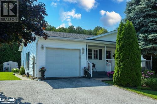 Ranch-style home featuring a porch and a garage - 69 St James Place, Wasaga Beach, ON - Outdoor