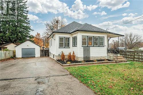 View of side of home featuring a lawn, an outbuilding, and a garage - 72 Elgin Street S, Cambridge, ON - Outdoor