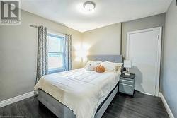 Bedroom featuring dark wood-type flooring - 