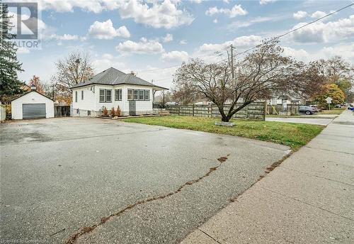 View of front of property with an outdoor structure, a front yard, and a garage - 72 Elgin Street S, Cambridge, ON - Outdoor