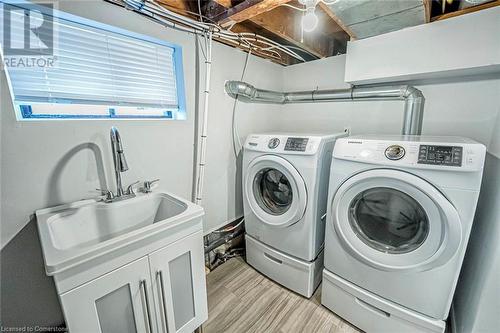 Clothes washing area featuring washer and dryer and light wood-type flooring - 72 Elgin Street S, Cambridge, ON - Indoor Photo Showing Laundry Room