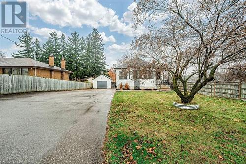 View of yard featuring a garage and an outbuilding - 72 Elgin Street S, Cambridge, ON - Outdoor