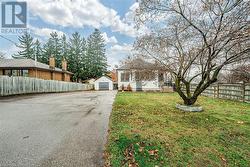 View of yard featuring a garage and an outbuilding - 