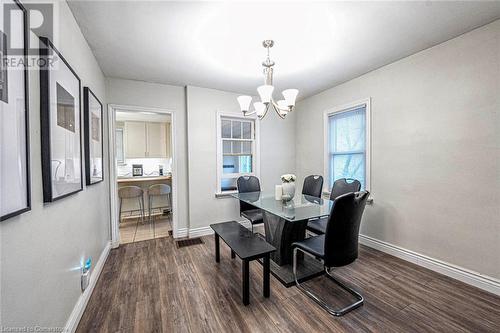 Dining area featuring dark hardwood / wood-style flooring and an inviting chandelier - 72 Elgin Street S, Cambridge, ON - Indoor Photo Showing Dining Room