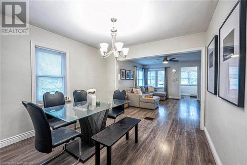 Dining space with ceiling fan with notable chandelier and dark hardwood / wood-style floors - 72 Elgin Street S, Cambridge, ON - Indoor Photo Showing Dining Room