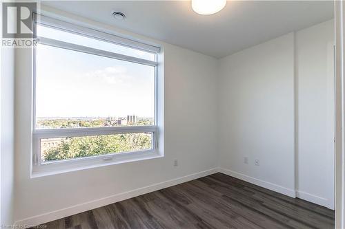 Unfurnished room featuring dark wood-type flooring - 479 Charlton Avenue E Unit# 404, Hamilton, ON - Indoor Photo Showing Other Room