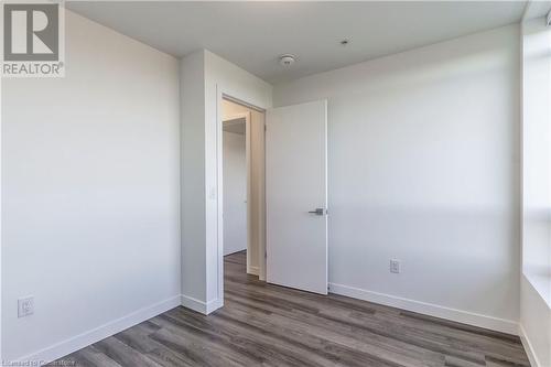 Empty room with dark wood-type flooring - 479 Charlton Avenue E Unit# 404, Hamilton, ON - Indoor Photo Showing Other Room