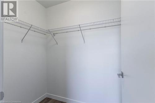 Walk in closet featuring dark wood-type flooring - 479 Charlton Avenue E Unit# 404, Hamilton, ON - Indoor With Storage