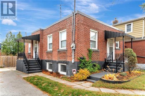 View of front of property showing the main floor unit entrance (on the left), as well as the basement unit entrance (on the front of the house). - 306 Paling Avenue, Hamilton, ON - Outdoor With Facade