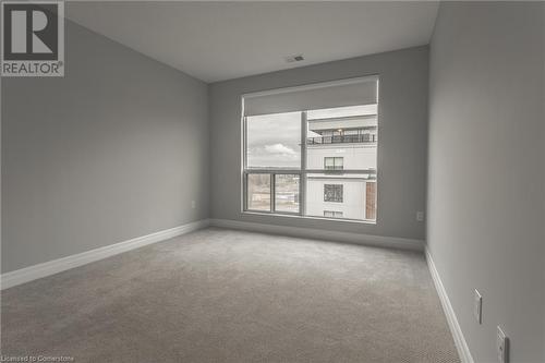 View of carpeted empty room - 460 Callaway Road Unit# 910, London, ON - Indoor Photo Showing Other Room