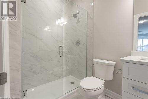 Bathroom featuring vanity, toilet, and a shower with door - 460 Callaway Road Unit# 910, London, ON - Indoor Photo Showing Bathroom