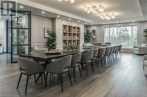 Dining area featuring dark hardwood / wood-style flooring and a raised ceiling - 460 Callaway Road Unit# 910, London, ON - Indoor Photo Showing Dining Room