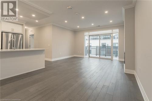 Empty room featuring dark hardwood / wood-style floors and ornamental molding - 460 Callaway Road Unit# 910, London, ON - Indoor