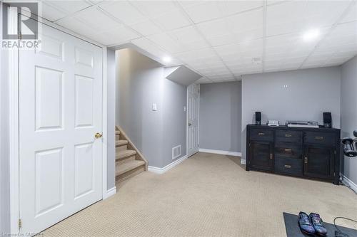 Basement with light carpet and a paneled ceiling - 259 Littlewood Drive, Oakville, ON - Indoor